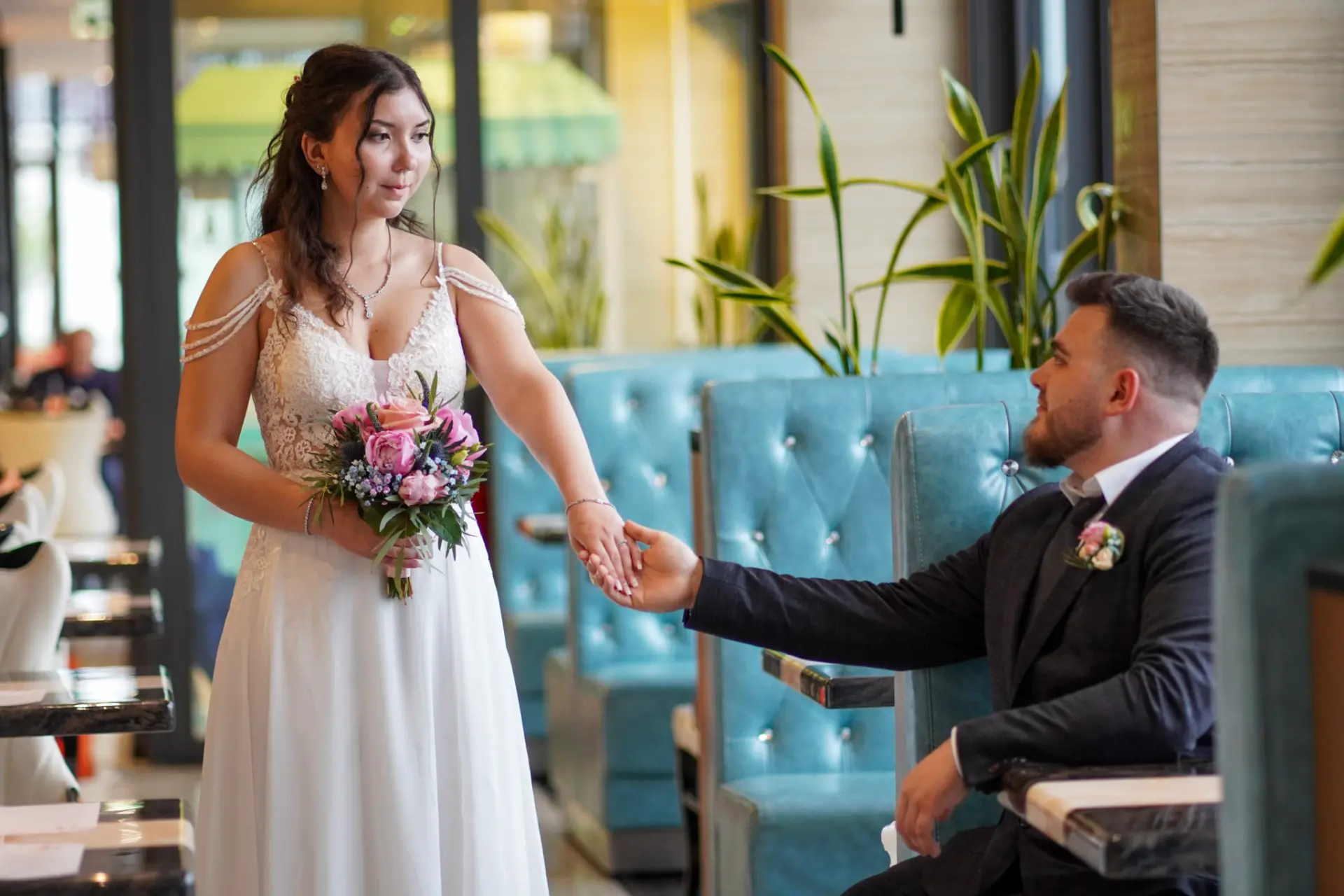 Bride and groom holding hands in a restaurant, Landsberg am Lech